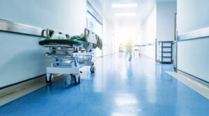 Doctors or nurses walking in hospital hallway, blurred motion.